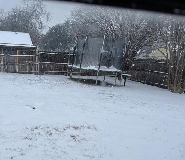 Photo of a backyard trampoline in the snow